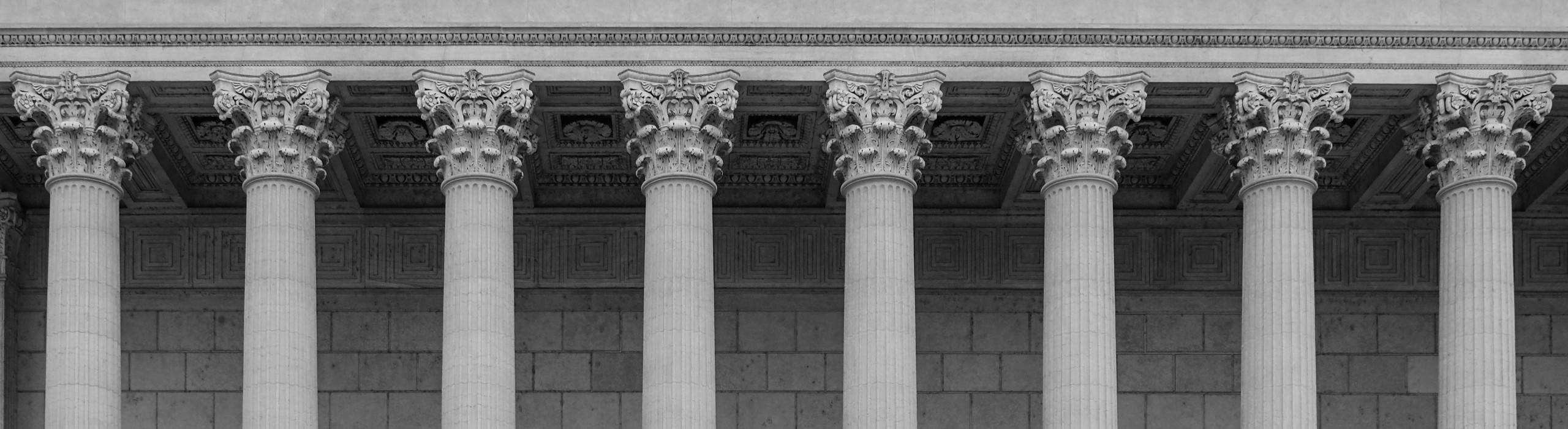 Farrell & Thurman, P.C. signature banner of courthouse pillars in black and white.